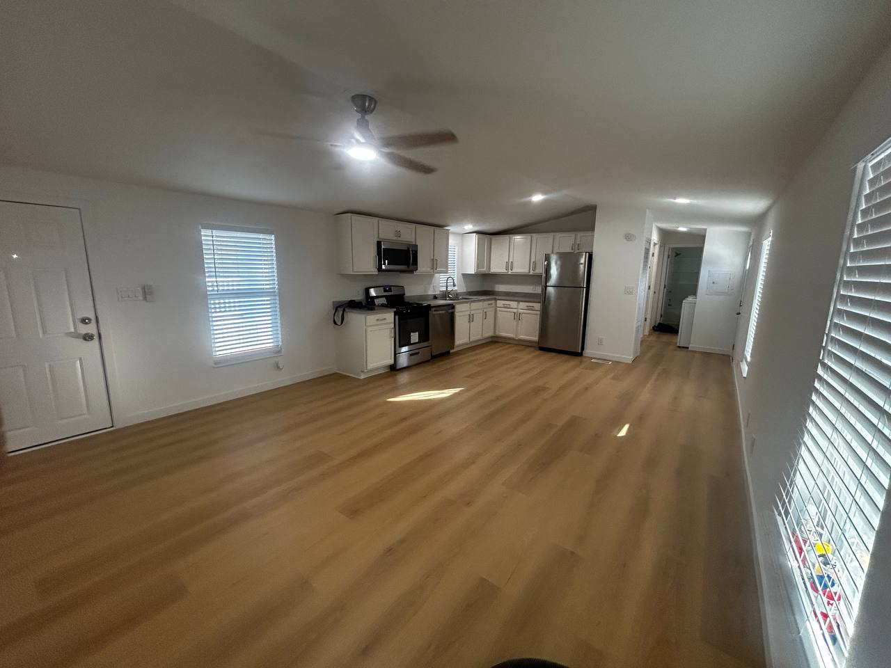 Renovated mobile home kitchen with new flooring and stainless appliances